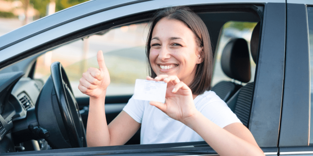 woman holding a drivers license