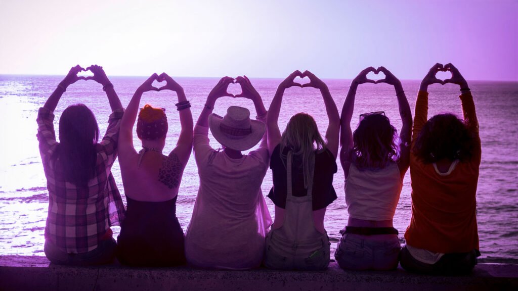 Women doing heart shapes for IWD 2024